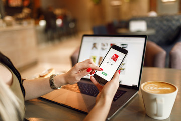 Women hands using smartphone and laptop computer for online shopping. Payment Detail page display.