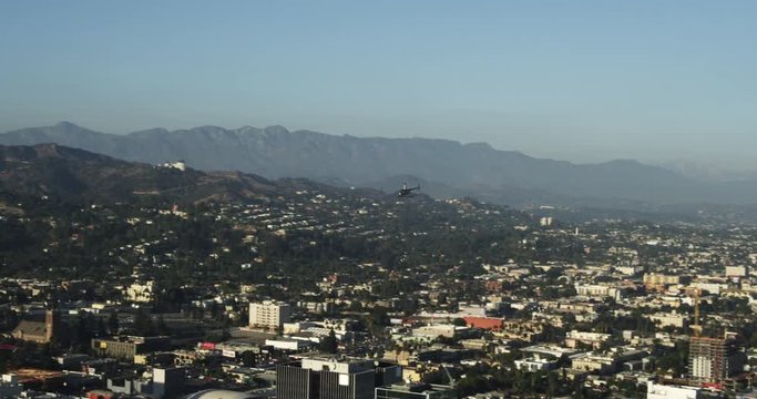 Helicopter soars over Los Angeles, aerial