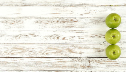 Fresh apples on white wooden desk and free space for your decoration. 