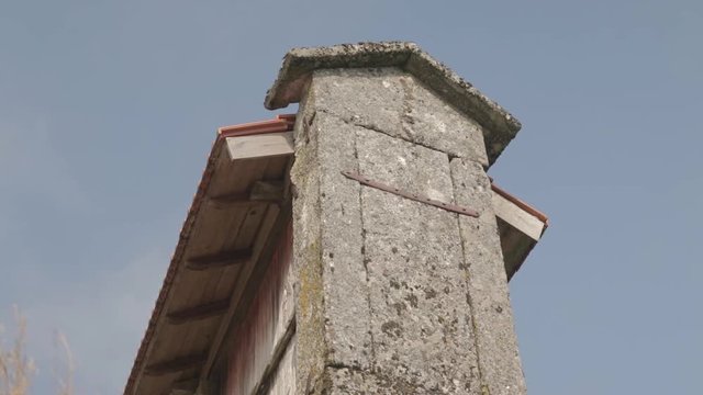 Low angle close up shot of a granary alled espigueiro in a rural village on a hill Friaes Tras-os-Montes Portugal