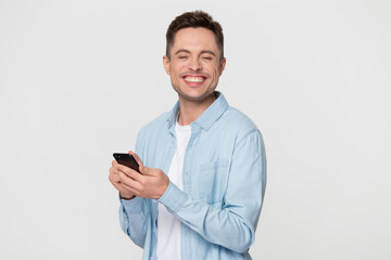 Excited Caucasian man on grey background happy get good message