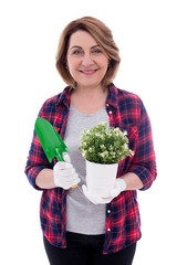 portrait of mature woman with potted plant and shovel isolated on white background