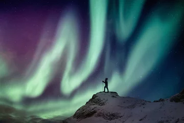 Keuken foto achterwand Man climber standing on snowy peak with aurora borealis and starry © Mumemories