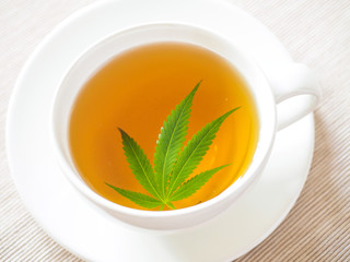 tea with marijuana. Cannabis leaf is brewed in herbal decoction to treat pain and increase appetite. concept of marijuana use for medicinal purposes.