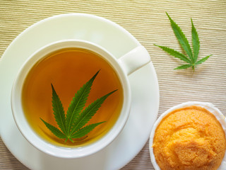 Breakfast with sweet cookies. tea with marijuana. Cannabis leaf is brewed in herbal decoction to treat pain and increase appetite. concept of marijuana use for medicinal purposes.