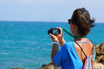 A tourist photographs the sea in Crete