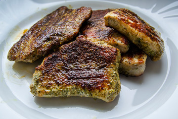 Homemade steak on white plate grilled in spices