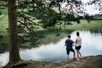 Couple enjoying the scenery in front of a lake