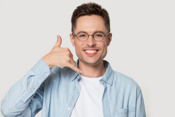 Smiling Caucasian man in glasses show call me gesture