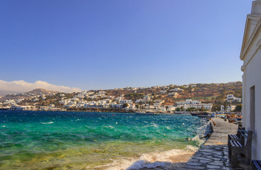 Fototapeta na wymiar View of an island in mediterranean. Panoramic view of old town and harbor of Mykonos, Cyclades, Greece. Panorama of traditional greek village with white houses in Cyclades Islands, Europe.