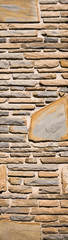 Vertical background with stone tiles and bricks in different geometrical shapes. Decorative wall