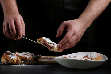 baker decorating on dark background. recipe concept