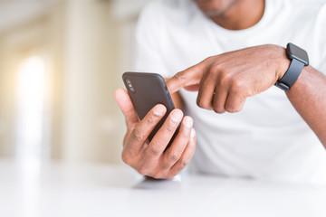 Close up of african american man hands using smartphone