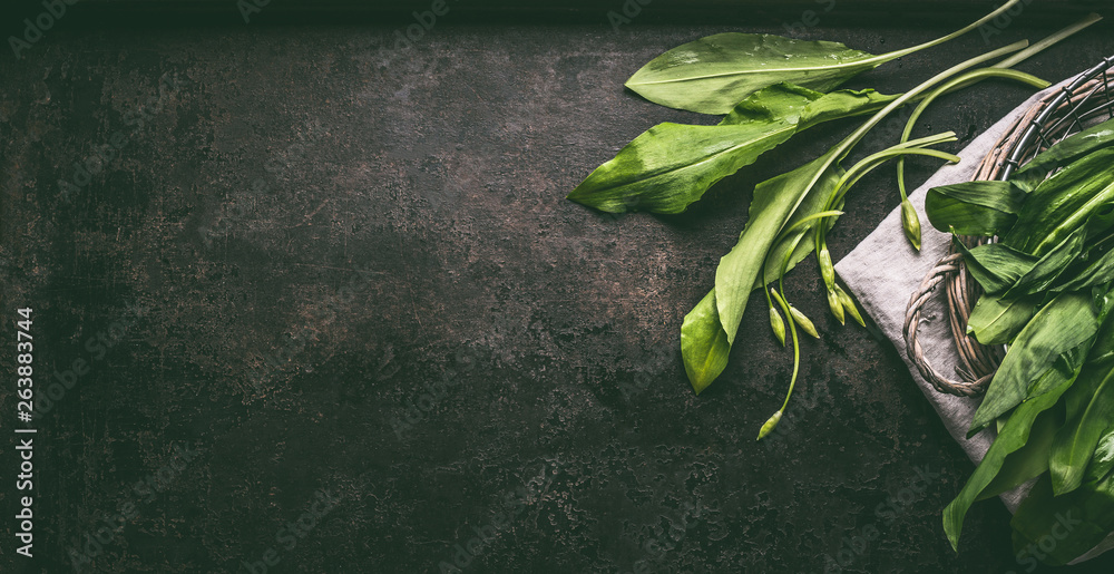 Sticker bunch of fresh ramson, wild garlic, leaves on dark rustic background, top view. healthy spring seaso