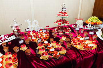 candy bar with cupcakes on a golden tray decorated with raspberr