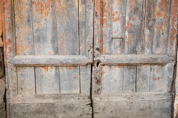 old wooden doors on Piazza Roma in Monteriggioni, Tuscany, Italy