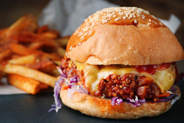 fresh tasty beef burger with cheese on wood background