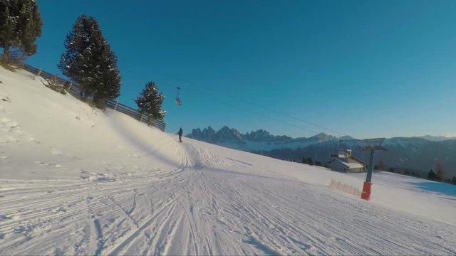 cable car on the plose mountain in the dolomite mountains. winter view to odles dolomites. man walking with dog