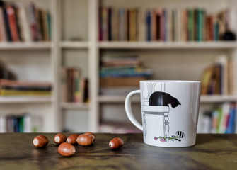 cup of fun tea with acorns on the table