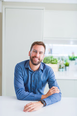 Handsome man wearing glasses and smiling relaxed at camera