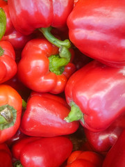 Background cut red sweet pepper in basket bulgarian pepper fresh, assorted colorful capsicum paprika on a counter in the supermarket.