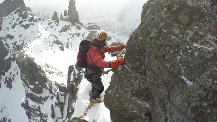 POINT OF VIEW of the second climber watching the first getting over a difficult passage.