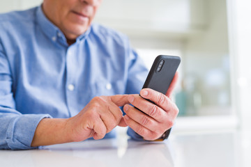 Close up of man hands using smartphone over white table