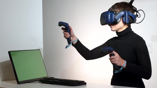 Elegant woman architect imagining architectural project with virtual reality glasses sitting at working place. young girl interior designer wearing vr goggles creative idea at desk.