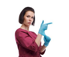 European woman doctor in medical gloves. Woman superman, glove gun. Close-up portrait on a white background. Isolate