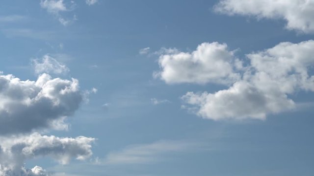 Only summer blue sky with two layers of moving gray clouds. Full HD Time Lapse footage
