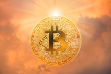 Double exposure of bitcoin with sunlight and dramatic sky
