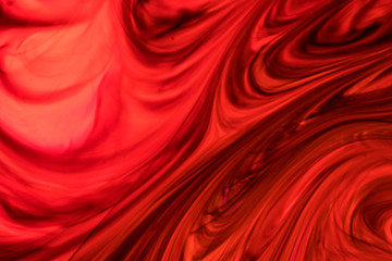 Background of red, orange, black ink waves