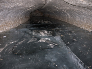 cave tunnel with ice floor, Pinega Nature Reserve, Arkhangelsk region, Russia