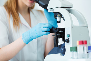 Scientist researcher using microscope in laboratory. Medical healthcare technology and...