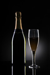 Champagne Bottle and Glass on Black Background