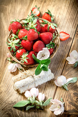 Delicious fresh strawberry, strawberis in wicker basket on table