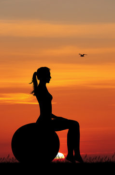 girl doing pilates at sunset