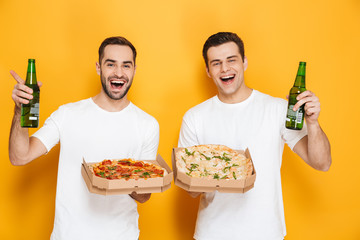 Two cheerful excited men friends wearing blank t-shirts