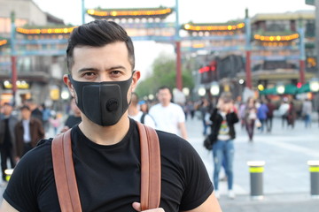 Fototapeta na wymiar Man using pollution mask in Asia