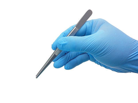 Hand of surgeon in blue medical glove holding a tweezers isolated on white background with clipping path