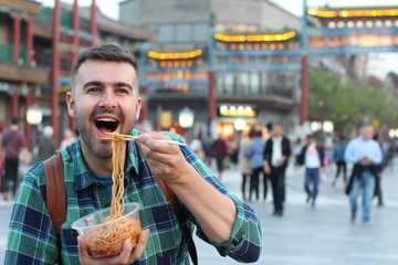 Tourist in Asia eating noodles outdoors