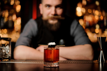 Close-up of alcohol cocktail with bartender on background