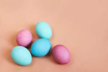 Multicolored easter eggs on bright pink background