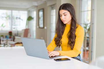 Beauitul young woman working using computer laptop concentrated