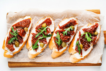 bruschetta with tomato, cream cheese and arugula