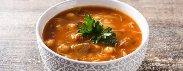 Harira soup in bowl on wooden table. Typical Moroccan food. Ramadán concept.Panoramic view