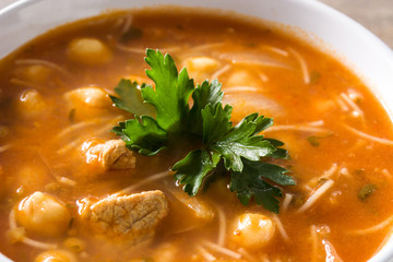 Harira soup in bowl on wooden table. Typical Moroccan food. Ramadán concept.Close up