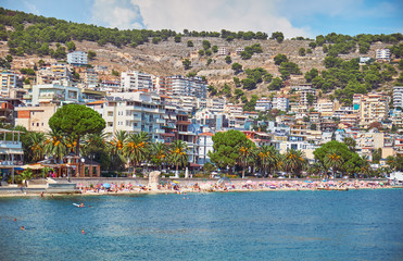  View of the city beach in summer in the holiday season. Saranda, Albania.