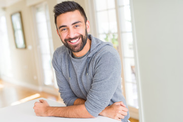 Handsome man smiling cheerful with a big smile on face showing teeth, positive and happy expression