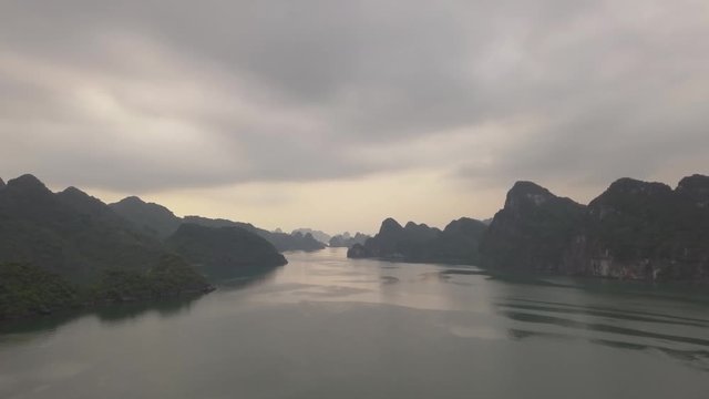 Flying over Ha Long Bay, Vietnam. Drone straight fly into the distance.